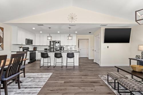 an open kitchen and dining room with a table and chairs at Heated Pool & Pet Friendly - Minutes To Beach - Spacious Backyard - FLPCB38 in Panama City Beach