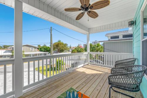 a porch with two chairs and a ceiling fan at Heated Pool & Pet Friendly - Minutes To Beach - Spacious Backyard - FLPCB38 in Panama City Beach