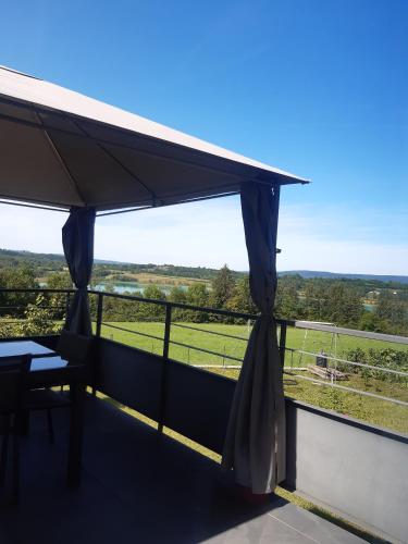 a balcony with a view of a field at Gîte les Griffons in Clairvaux-les-Lacs