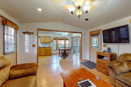 a living room with a couch and a flat screen tv at Whaleshead Grove in Carpenterville