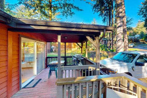 a covered deck with a table and a car at Whaleshead Grove in Carpenterville