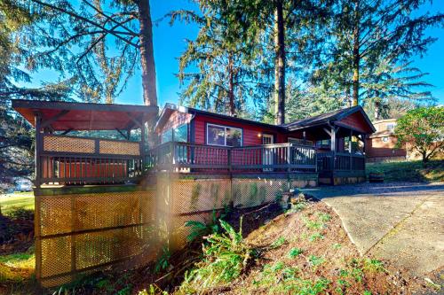 a house with a wrap around porch in the woods at Whaleshead Grove in Carpenterville