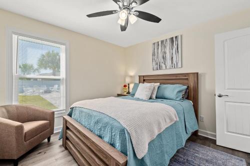 a bedroom with a bed and a ceiling fan at Heated Pool & Pet Friendly - Minutes To Beach - Spacious Backyard - FLPCB38 in Panama City Beach