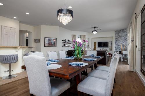 a dining room and living room with a table and chairs at Music Lovers Paradise 7 Bed Pool Home and Game Room in Indio