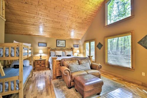 a log cabin bedroom with a bunk bed and a bed and a couch at The Oakwood house in Rising Fawn