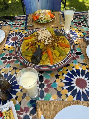 a table with a plate of food on a table at RIAD REDWAN in Marrakech