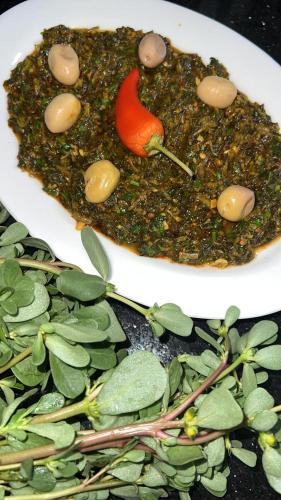a plate of food on a table with leaves at RIAD REDWAN in Marrakech