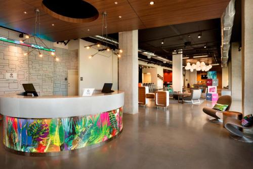 a lobby with a counter with laptops on it at Aloft Hillsboro-Beaverton in Hillsboro