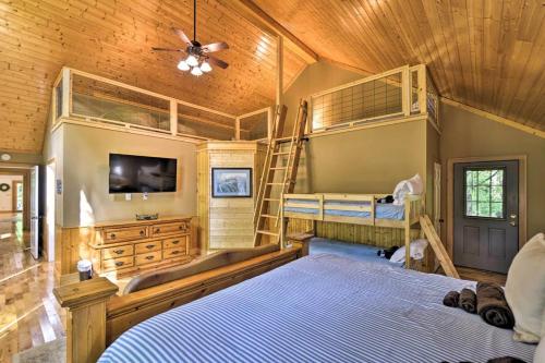 a bedroom with two bunk beds and a tv at The Oakwood house in Rising Fawn