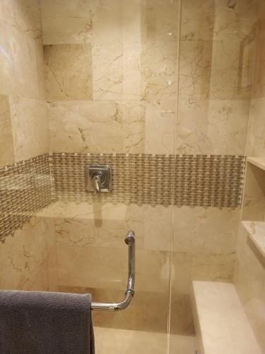 a bathroom with a shower with a towel at Penthouse Studio 2 blocks from Los Muertos beach in Puerto Vallarta