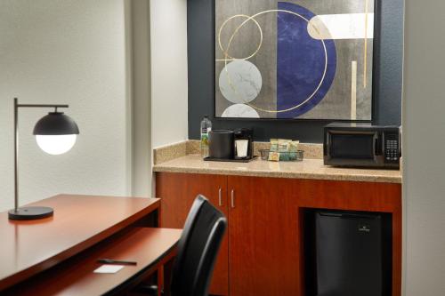 a kitchen with a table and a desk with a microwave at Courtyard by Marriott Nashville Brentwood in Brentwood