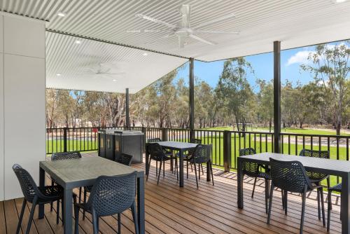 a patio with tables and chairs on a deck at Discovery Parks - Echuca in Echuca