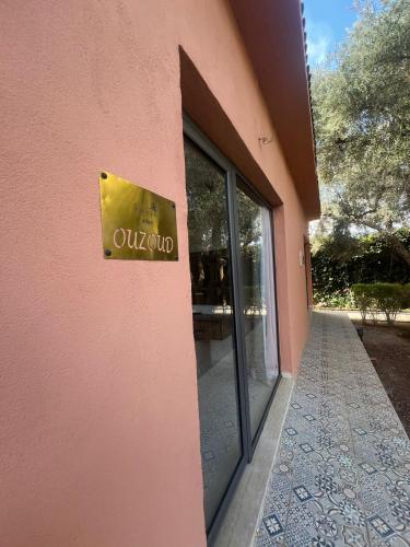 a sign on the side of a pink building at RIAD REDWAN in Marrakech