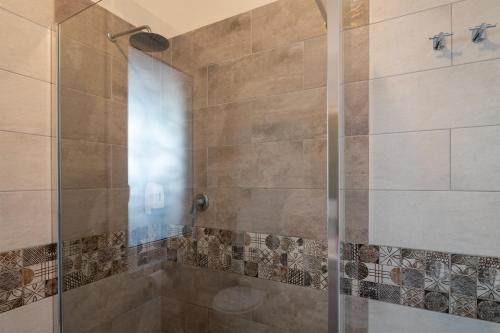 a bathroom with a shower with a glass door at Conca Verde Apartments in Vallecrosia