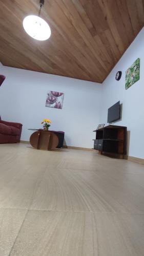 an empty room with a table and a piano at Résidence Merveilles D20 in Kribi