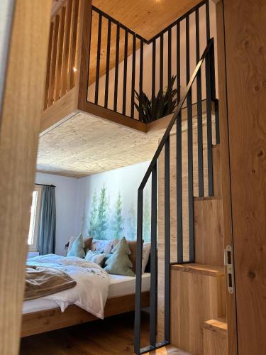a bedroom with a bunk bed with a staircase at Casa Ladina 4 in Falera