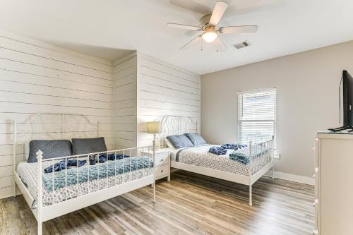ein Schlafzimmer mit zwei Betten und einem Deckenventilator in der Unterkunft The Beach House Bolivar Peninsula Family Getaway in Crystal Beach