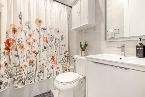 a bathroom with a toilet and a shower curtain at NYC Gateway, 30minutes from Manhattan in Jersey City