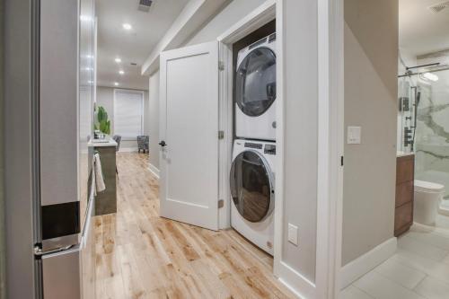 a white laundry room with a washer and dryer at One Sky Loft in Philadelphia