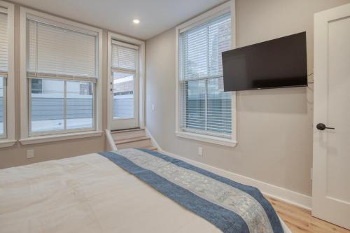 a bedroom with a bed and a flat screen tv at One Sky Loft in Philadelphia