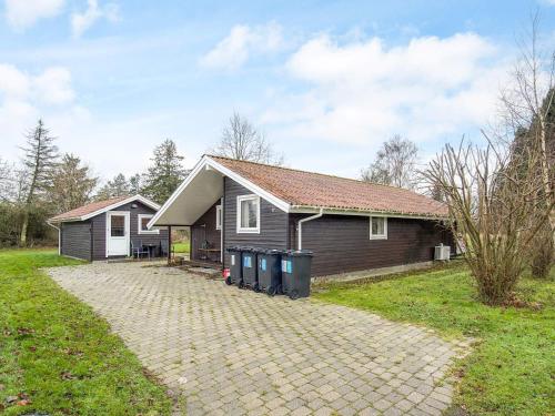 a house with a brick driveway in front of it at 6 person holiday home in Skibby-By Traum in Skibby