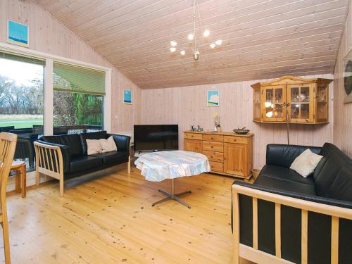 a living room with black leather furniture and a table at 6 person holiday home in Skibby-By Traum in Skibby