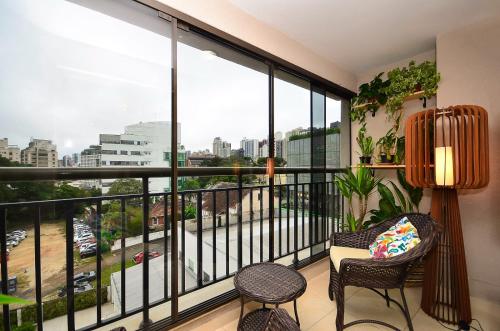 a balcony with a view of a city at Home Batel in Curitiba