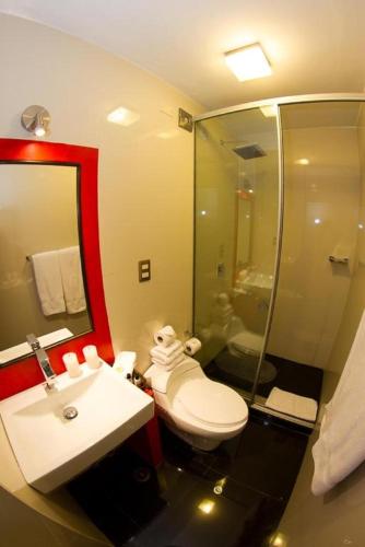 a bathroom with a toilet and a sink and a shower at Wakapunku Boutique Hotel in Cusco