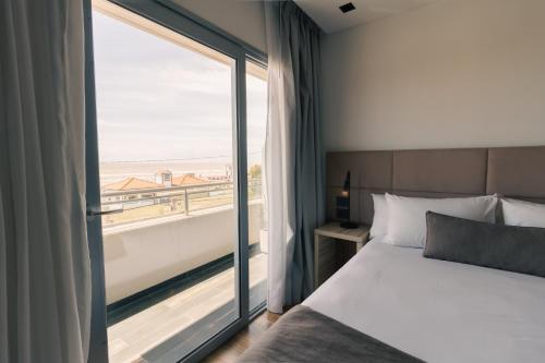 a bedroom with a bed and a large window at Neco Boutique Hotel in San Bernardo