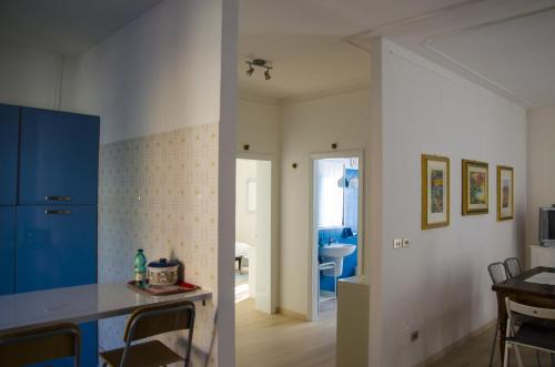 a kitchen and a living room with a blue refrigerator at La Signora Dei Fiori in Gubbio