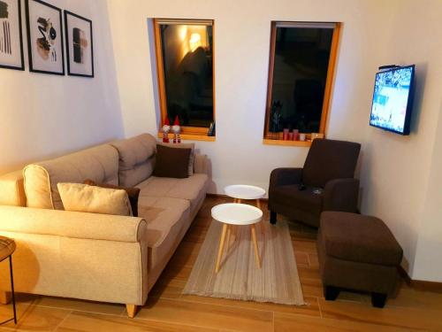 a living room with a couch and a chair at Apartment Holiday Ravna Planina in Pale