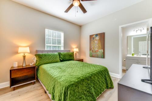 a bedroom with a green bed and a ceiling fan at Near Shopping and Dining Pet-Friendly Dallas Apt! in Gastonia