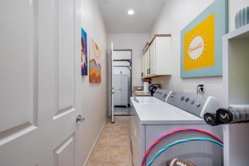 a kitchen with a sink and a counter top at Music Lovers Paradise 7 Bed Pool Home and Game Room in Indio