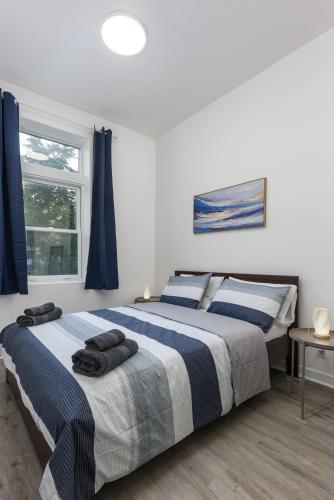 a bedroom with two beds and a window at Brand new 2 bedroom in the heart of the city in Montréal