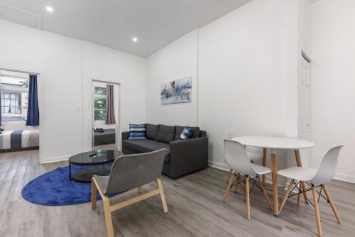 a living room with a couch and a table and chairs at Brand new 2 bedroom in the heart of the city in Montréal
