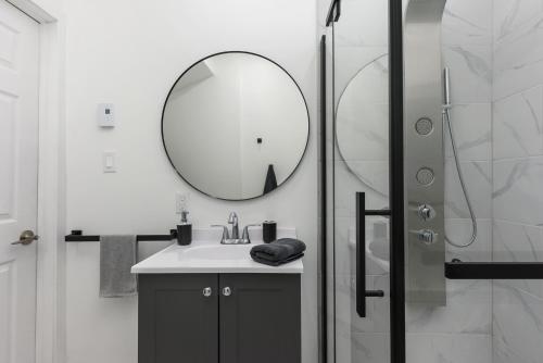a bathroom with a sink and a mirror at Brand new 2 bedroom in the heart of the city in Montréal
