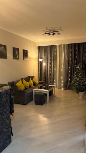 a living room with a couch and a christmas tree at Tsaghkadzor Alvina Complex 12 Project in Tsaghkadzor