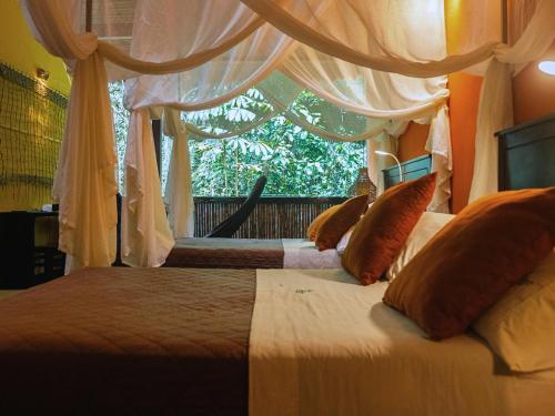 a bedroom with two beds and a large window at Tambopata Research Center in Tambopata