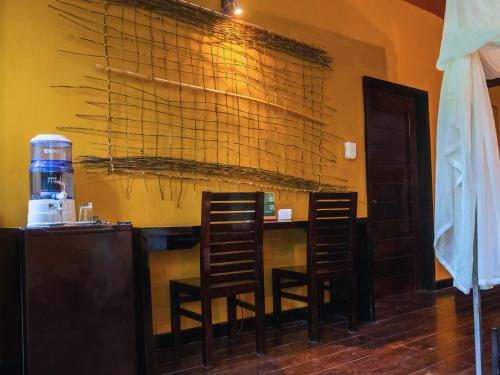 a bar with two chairs and a table in a room at Tambopata Research Center in Tambopata