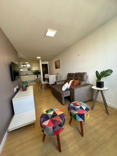 a living room with a couch and two chairs at Apartamento Sua Casa em João Pessoa in João Pessoa