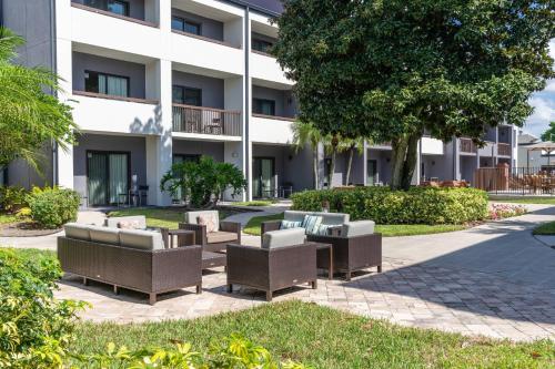 a row of chairs in front of a building at Courtyard by Marriott Orlando Airport in Orlando