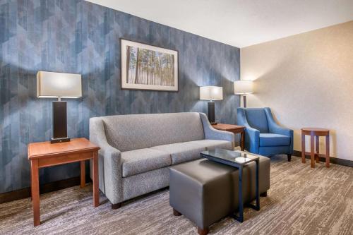 a living room with a couch and a chair at Drury Plaza Hotel Valdosta in Valdosta
