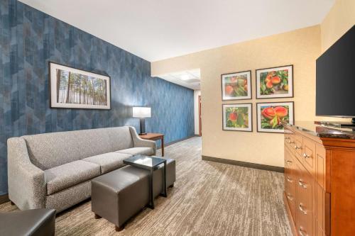 a living room with a couch and a table at Drury Plaza Hotel Valdosta in Valdosta