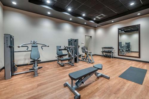 a gym with several treadmills and exercise bikes at Drury Plaza Hotel Valdosta in Valdosta