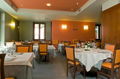 a dining room with white tables and chairs at Hotel Mosca in Monza