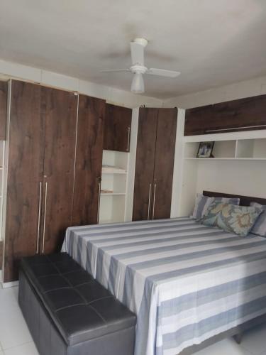 a bedroom with a bed and a ceiling at Cantinho da nete in Ilhéus