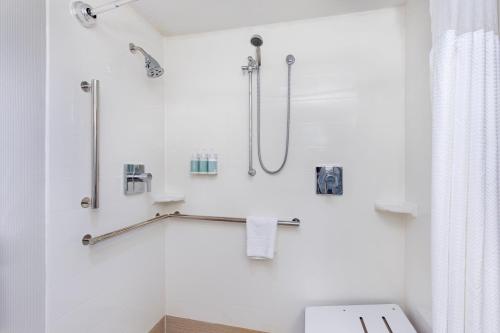 a white bathroom with a shower and a toilet at Courtyard by Marriott Lexington North in Lexington
