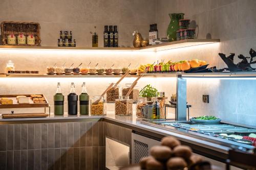 a restaurant kitchen with a counter with lots of food at DoubleTree by Hilton Hobart in Hobart
