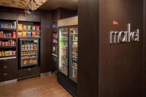a grocery store aisle with two refrigerators at Courtyard Seattle Southcenter in Tukwila
