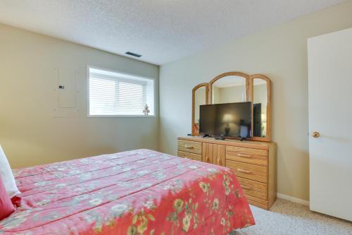 a bedroom with a bed and a dresser with a tv at Lincoln City Condo Pool Access, Walk to Beach! in Lincoln City
